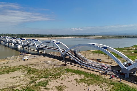 AN AERIAL view shows damaged vehicles on a section of a collapsed bridge in Santa Maria town, Isabela province.