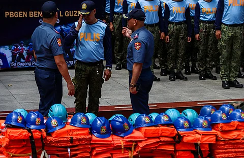 Officials from the Manila Police District present the rescue gear which include life vests, helmets and cutting tools during the Philippine National Police’s annual inspection of disaster response equipment at the MPD headquarters in Manila on Wednesday.