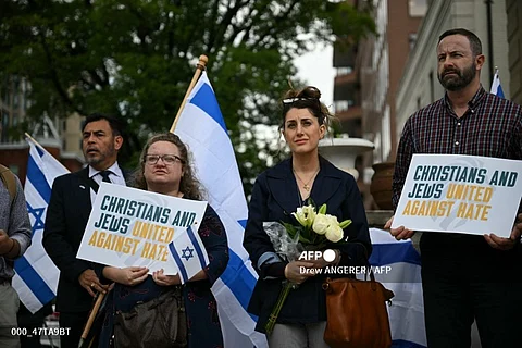 People gather outside the Capital Jewish Museum in Washington, DC, on May 22, 2025, holding signs and Israeli flags in support after two Israeli embassy staffers, Yaron Lischinsky and Sarah Lynn Milgrim, were shot dead the night before by a gunman shouting "free Palestine," prompting shock and outrage from US officials and Israeli diplomats.