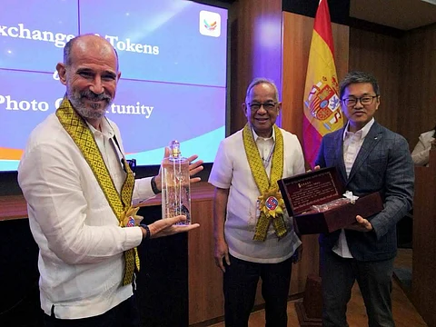 Spanish Ambassador to the Philippines Miguel Ultray Delgado displays a bottle of Taiwanese fermented sorghum liquor with gold flakes, a gift from Best Chang, assistant to the CEO of Xantheng Subic International Corp. Subic Bay Metropolitan Authority Chairman and Administrator Eduardo Jose L. Aliño joins them for a photo at the boardroom of the Administration Building in Subic Bay Freeport.