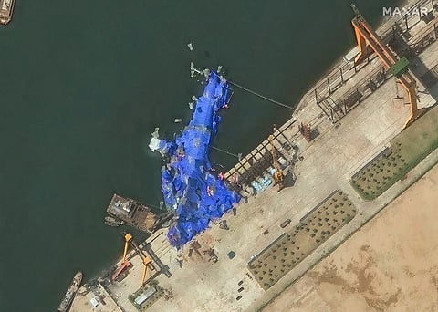 This handout satellite image courtesy of Maxar Technologies taken on May 23, 2025, shows a general view of a new North Korean warship at the harbor after its launch accident in Chongjin. North Korea has begun an investigation into the accident that occurred during the May 21, 2025, launch, state media said on May 23, 2025, assessing the damage as "not serious."