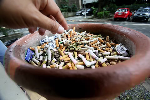 AN overflowing cigarette bin at a designated smoking area in the University of the Philippines Diliman, Quezon City.