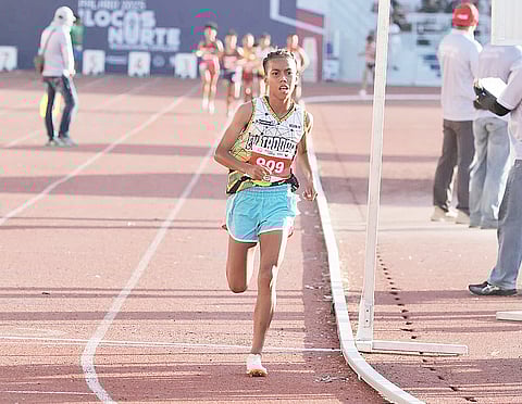 Chrishia Mae Tajarros leaves her pursuers at bay en route to winning the women’s 3000m — the 65th Palarong Pambansa’s first gold — Monday in Laoag, Ilocos Norte.
