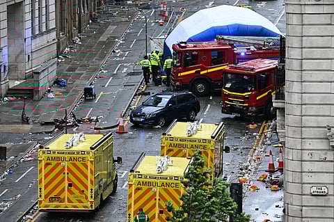 Police officers cover with an inflatable tent, behind a firefighter vehicle, the tents delimiting the scene of an incident in Water Street, on the sidelines of an open-top bus victory parade for Liverpool's Premier League title win, in Liverpool, north-west England on May 26, 2025. A car collided with a number of pedestrians in Liverpool, northern England, on May 26 evening during Liverpool FC's Premier League victory parade, police said. Police said they were contacted shortly after 6pm (1700 GMT) ‘following reports of a collision between a car and a number of pedestrians’ in the city center. One man has been arrested, according to the police, who did not say whether there were any casualties.