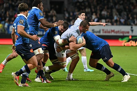 Clermont's Australian full back Alex Newsome is tackled during the French Top14 rugby union match between Castres Olympique and ASM Clermont Auvergne at Pierre-Fabre stadium in Castres, southwestern France, on 24 May 2025.