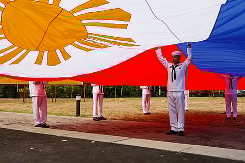 Philippine Navy personnel raise the national flag during National Flag Day celebration and the start of the 127th Independence Day commemoration at Heritage Park in Barangay Alapan, Imus, Cavite, on Wednesday, 28 May 2025. The Philippine flag was first unfurled at the site in 1898 following the Battle of Alapan between Filipino revolutionaries and Spanish forces.