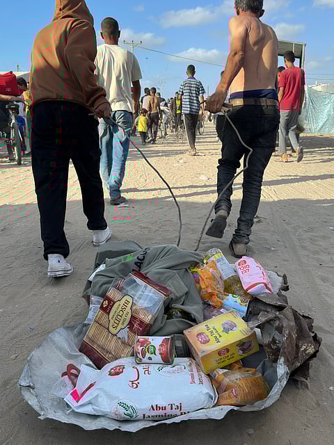 DISPLACED Palestinians receive food packages from a United States-backed foundation pledging to distribute humanitarian aid in western Rafah in the southern Gaza Strip on 27 May 2025.