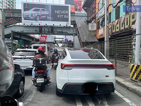 A hybrid vehicle obstructs the bike lane along EDSA-Cubao near Aurora Boulevard in Quezon City on Thursday, 29 May 2025, the fourth day of the "No Contact Apprehension Policy" implementation. Despite being exempt from the number coding scheme during the EDSA rehabilitation, hybrid and electric vehicles remain subject to regular traffic violations.