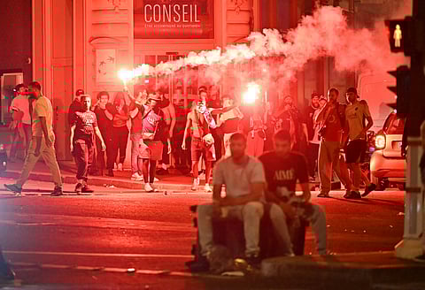 PARIS Saint-Germain (PSG) supporters gather holding flares on a street in Paris early June 1, 2025, during celebrations following their 5-0 victory in the UEFA Champions League final football match between Paris Saint-Germain (PSG) and Inter Milan held in Munich.
