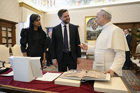 This photo taken and handout on 19 May 2025 by The Vatican Media shows US Vice President JD Vance and his wife Usha exchanging gifts during a private audience with Pope Leo XIV in The Vatican.