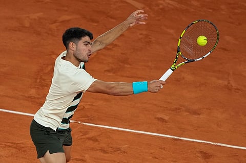 Spain's Carlos Alcaraz plays a backhand return to US Tommy Paul during their quarter-final men's singles match on day 10 of the French Open tennis tournament on Court Philippe-Chatrier at the Roland-Garros Complex in Paris on 3 June 2025.