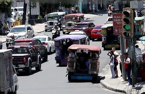 Commuters along EDSA in Quezon City wait for public transport to arrive. The government has announced the postponement of the rehabilitation of the major metro thoroughfare but the Transport department said that it was not canceled.