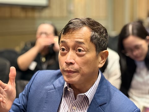 EDC President and Chief Operating Officer Jerome H. Cainglet speaks to reporters before parent firm’s annual stockholders meeting.