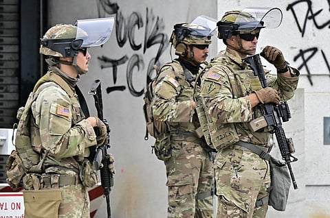 Members of the National Guard stand guard outside the Metropolitan Detention Center, MDC in downtown Los Angeles, California on June 8, 2025. US President Donald Trump deployed 2,000 troops on June 7 to handle escalating protests against immigration enforcement raids in the Los Angeles area, a move the state's governor termed "purposefully inflammatory." Federal agents clashed with angry crowds in a Los Angeles suburb as protests stretched into a second night Saturday, shooting flash-bang grenades and shutting part of a freeway amid raids on undocumented migrants, reports said.