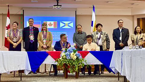 NOVA Scotia's Minister of Advance Education Brendan Maguire and Department of Migrant Workers Secretary Hans Cacdac sign a memorandum of understanding for enhanced protection of the rights and welfare of overseas Filipino workers in the Canadian province.