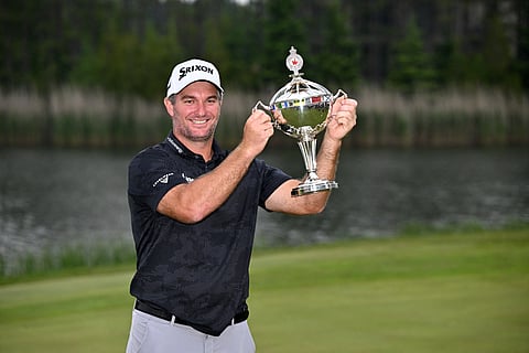 RYAN Fox lifts the trophy after surviving a grueling playoff battle with Sam Burns to win the Canadian Open.