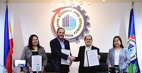 PEZA Director General Tereso Panga (third from left) and Aboitiz InfraCapital Economic Estates President Rafael Fernandez de Mesa (second from left) shake hands during the signing of the MOU, with Aboitiz InfraCapital as PEZA's investment partner.