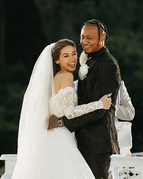Zeinab was every bit the radiant bride in a custom lace gown designed by world-renowned couturier Michael Cinco. Her groom, Bobby Ray, matched her grace and presence in a sharp black tuxedo with a crisp white rose pinned to his lapel.