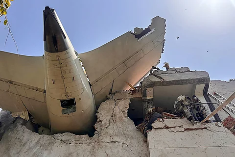Where’s the rest? The tail end of the ill-fated Indian plane juts from a building after crashing Thursday in the western city of Ahmedabad with 242 on board.