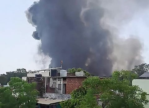 This frame grab from a video by @ashlovetea on June 12, 2025 made available on the Eurovision Social Newswire (ESN) platform via AFPTV shows a plume of smoke rising after Air India flight 171 crashed near the airport in Ahmedabad. The London-bound passenger plane crashed on June 12 in India's western city of Ahmedabad with 242 on board, aviation officials said in what the airline called a "tragic accident".