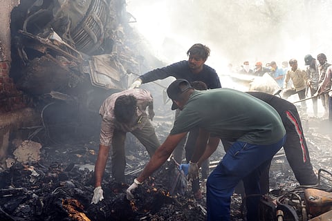 Rescue officials work at the site where Air India flight 171 crashed in a residential area near the airport in Ahmedabad on June 12, 2025. The London-bound passenger plane crashed on June 12 in India's western city of Ahmedabad with 242 on board, aviation officials said in what the airline called a "tragic accident."
