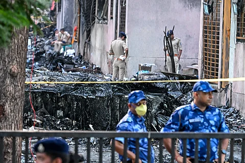Police stand guard at the site after Air India flight 171 crashed in a residential area near the airport in Ahmedabad on 13 June 2025.