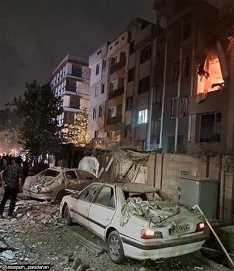 This handout photo released by Iran’s Revolutionary Guard Corps reportedly shows a building in Tehran hit in an Israeli strike.