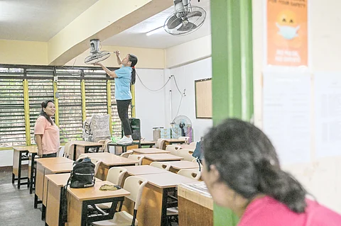 WITH rags, brooms, and quiet resolve, parents and teachers scrub the past away in a Manila classroom on Saturday — preparing the halls of learning for a new school year set to begin on Monday.