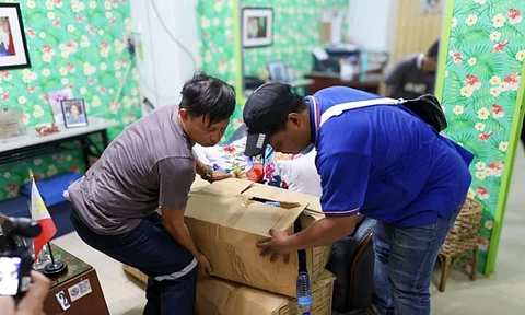 INDIVIDUALS carry boxes of donated school supplies during the distribution led by the Manila International Airport Authority in participation of the Brigada Eskwela 2025.