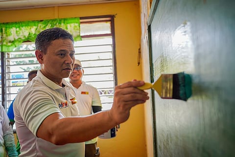 (FILES) EDUCATION Secretary Sonny Angara paints a blackboard during a school visit to kick off this year’s "Brigada Eskwela."