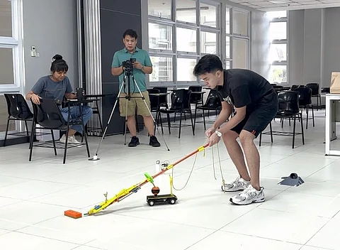 ABOITIZ Foundation scholar Jason Yabut tests a machine design as part of his project in the Mechanical Engineering Design class at UP-Diliman last semester.