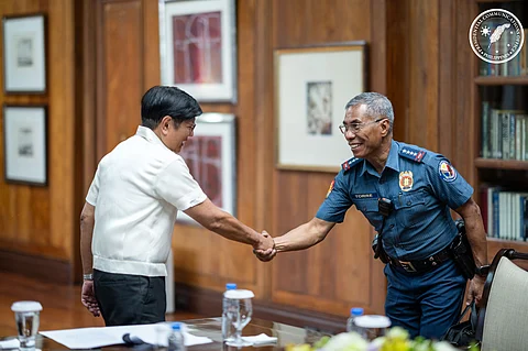 President Ferdinand Marcos Jr. (left) shakes hands with Philippine National Police chief Police General Nicolas Torre III after the PNP chief laid out plans for enhancing police visibility and intensifying peace and order measures during a meeting in Malacañang on Tuesday.