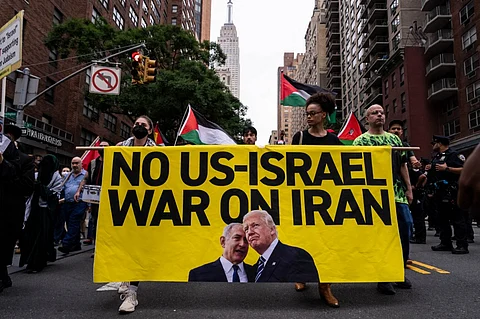 NEW YORK, NEW YORK - JUNE 18: People march during a rally calling for the Trump administration not to go to war with Iran, on June 18, 2025 in New York City. President Donald Trump said Wednesday he had not yet decided whether the U.S. military would take part in Israel's ongoing strikes on Iran.