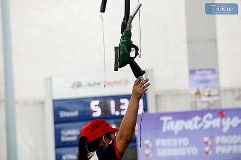 GAS station personnel assist motorists refueling at a station along East Avenue in Quezon City.