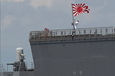 Rising Sun in Manila A sailor hoists the Japan Maritime Self-Defense Force ensign aboard JS Ise, a Hyuga-class helicopter destroyer, as it docks at the Manila International Port on June 21, 2025. The Ise, along with JS Suzunami, is in the Philippine capital for a three-day port call.