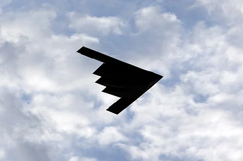 (FILES) A B-2 Stealth Bomber flies over the Washington Monument at the National Mall, during the Independence Day celebrations in Washington DC on July 4, 2020. A powerful American bunker-buster bomb, the only one capable of destroying Iran's deeply buried nuclear facilities, is Donald Trump's strategic weapon of choice should he decide to engage the US in conflict alongside Israel. The GBU-57, a 13-ton warhead capable of sinking dozens of meters before exploding, is all Israel needs to achieve its first war goal: blocking Teheran's construction of an atomic bomb.