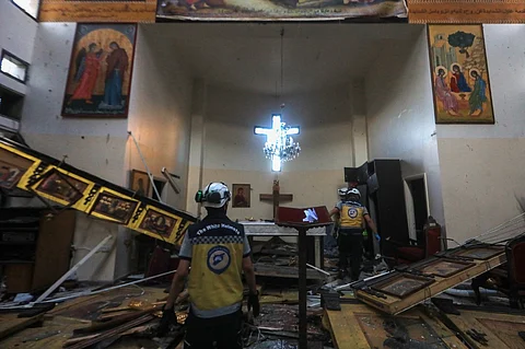 Rescuers inspect the damage at the site of a reported suicide attack at the Saint Elias church in Damascus' Dwelaa area on 22 June 2025. Syrian state media reported a suicide attack on a Damascus church on 22 June that caused casualties, as AFP correspondents at the scene saw first responders transporting people from the site.