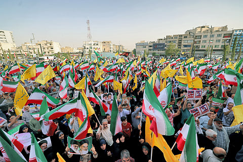 Iranians wave national flags and chant slogans as they celebrate a ceasefire between Iran and Israel at Enghlab Square in the capital Tehran on June 24, 2025. A fragile ceasefire in the Iran-Israel war appeared to be holding on June 24, after 12 days of strikes that saw Israel and the United States pummel the Islamic republic's nuclear facilities.