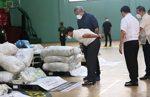 PRESIDENT Ferdinand Marcos Jr., joined by top security officials, inspects the P8.8 billion worth of shabu recovered from multiple coastal provinces during an ocular visit to the Philippine Drug Enforcement Agency headquarters in Quezon City on Tuesday. Marcos has ordered intensified maritime security to prevent future drug smuggling attempts.