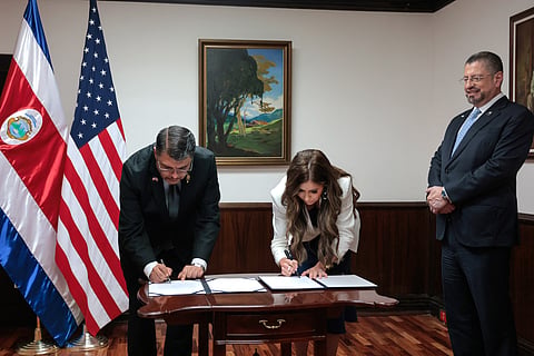 US Secretary of Homeland Security Kristi Noem (C), President of Costa Rica Rodrigo Chaves Robles (R) and Costa Rica Minister of Public Security Mario Zamora Cordero (L) participate in a signing ceremony for the Global Entry Letter of Intent at the Casa Presidencial on June 25, 2025 in San Jose, Costa Rica.