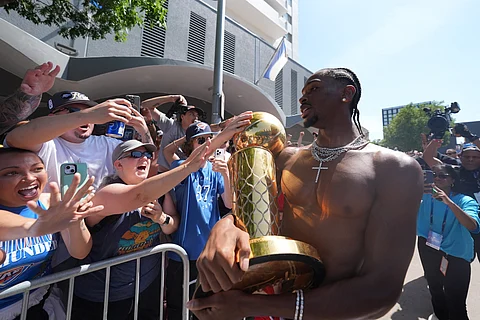 SHAI Gilgeous-Alexander presents the Larry O’Brien trophy to Thunder fans during their victory parade in the streets of Oklahoma City.