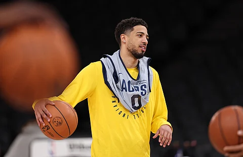 Indiana Pacers' US guard #0 Tyrese Haliburton holds the ball as he attends a training session at the Accor Arena - Palais Omnisports de Paris-Bercy - in Paris on January 22, 2025.