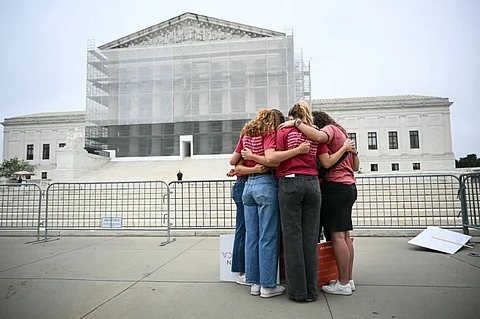 A group of women pray outside the US Supreme Court, on the final day of the Court's term, in Washington, DC, on June 27, 2025. The US Supreme Court is to issue its final rulings on Friday ahead of its summer break, including cases involving birthright citenzenship, porn site age verification, students and LGBTQ-themed content, and voting rights.