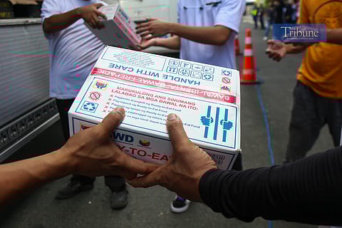 DSWD workers unload ready-to-eat food packs at North Port Terminal in Manila on 27 June 2025 as part of prepositioning efforts for faster emergency response.