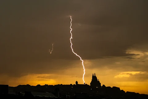 THIS photograph shows a lightning bolt falling near Sacre Coeur Basilica in Montmartre during a thunderstorm, in Paris on June 25, 2025.