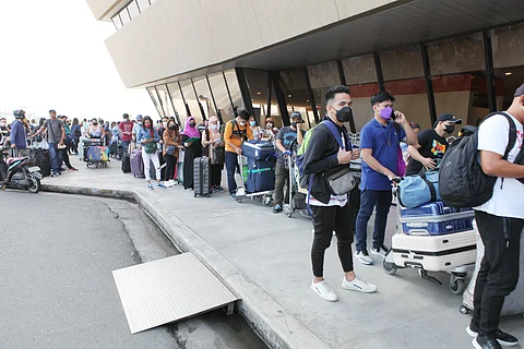 Filipinos scheduled for international travel line up at Ninoy Aquino International Airport Terminal 1.