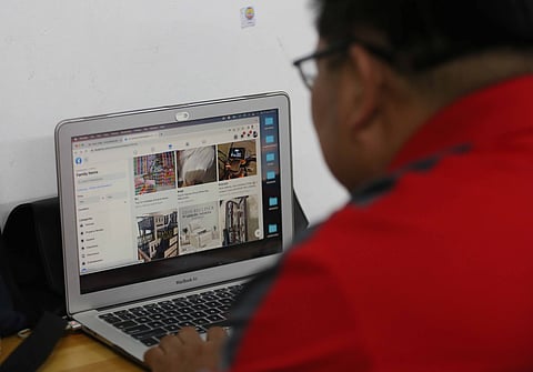 A man browses products being sold online on his laptop in Quezon City on Saturday. In the digital age, online shopping is revolutionizing how we buy everything — from daily essentials to big-ticket items.