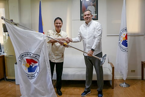 Newly-appointed chairman PATRICK ‘Pato’ Gregorio (left) receives the symbolic flag of the Philippine Sports Commission from Richard ‘Dickie’ Bachmann during the turnover ceremony at the Rizal Memorial Sports Complex on Tuesday.