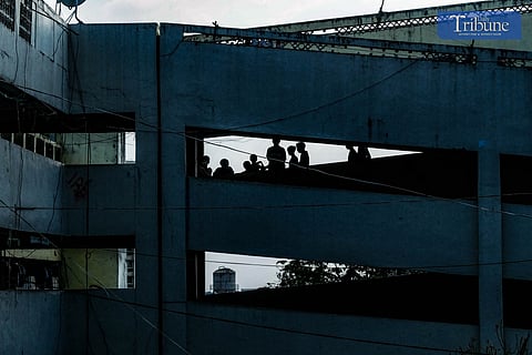 RESIDENTS in Tenement hanging out in its top floors.