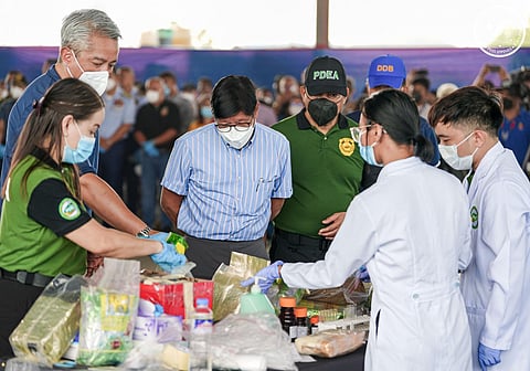 PRESIDENT Ferdinand Marcos Jr. observes as agents of the Philippine Drug Enforcement Agency sort the drugs that were destroyed last week.